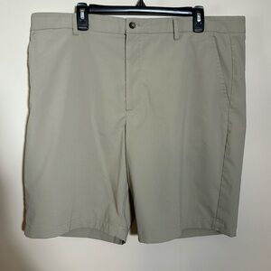Greg Norman golf shorts in tan color- poly spandex stretch fabric.
